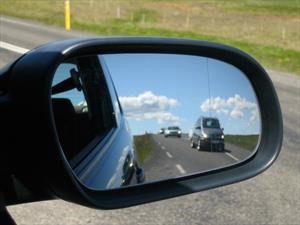 ¿A qué se debe que los objetos en el espejo derecho del automóvil están más cerca de lo que parece?